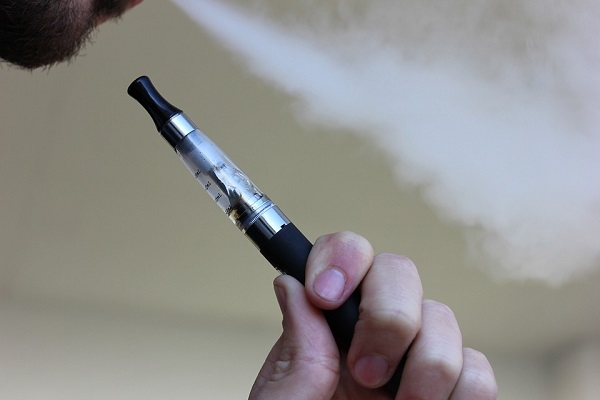 Electronic cigarette in man's hand