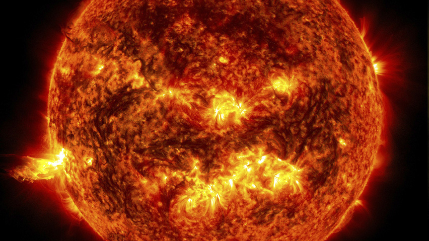 The bright light of a solar flare on the left side of the sun is seen in this NASA handout image