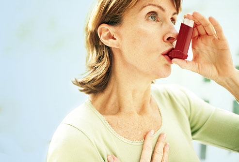 photolibrary_rf_photo_of_woman_using_asthma_inhaler