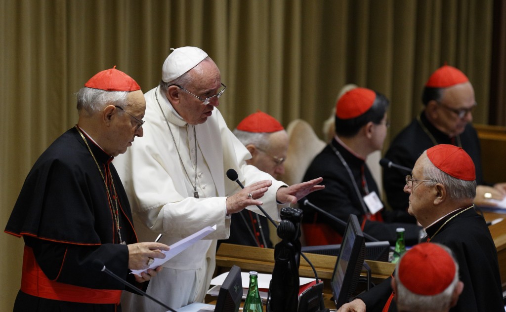 Pope Francis gestures as he talks with Cardinal Sodano before morning session of synod