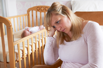 "woman in nursery suffering from postpartum depression""