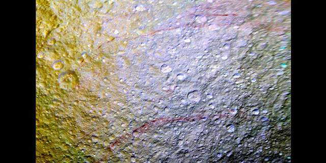 "Saturn's Moon Tethys Has Red Graffiti Sketches on Its Surface"