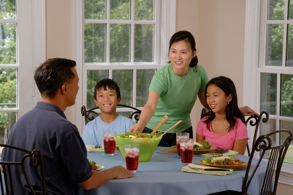 alt="family eating at the table"