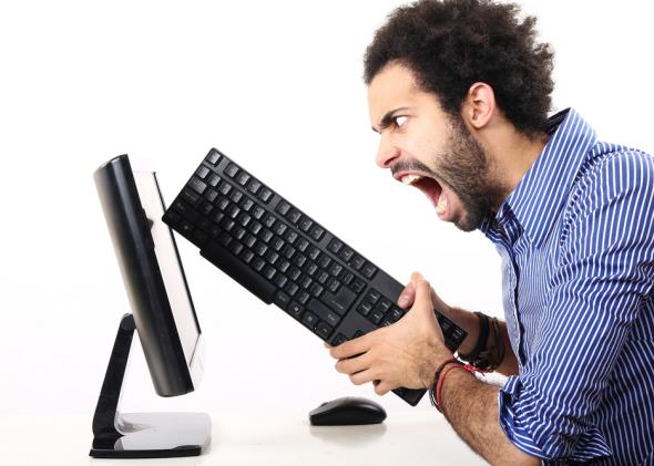 "angry Internet user hitting PC screen"