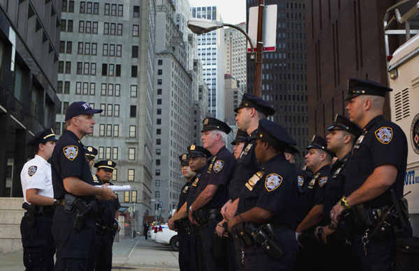 alt="New York Police Department Inspector James Kehoe (L) addresses NYPD officers before a Critical Response Vehicle deployment in New York August 24, 2011. The NYPD has worked since the September 11, 2001 al-Qaeda attacks on a long-term project to permanently increase vigilance in Lower Manhattan and Midtown, home to prominent financial institutions and national landmarks, in preparation for possible future attacks"