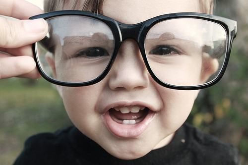 alt="adorable kid wears large glasses"