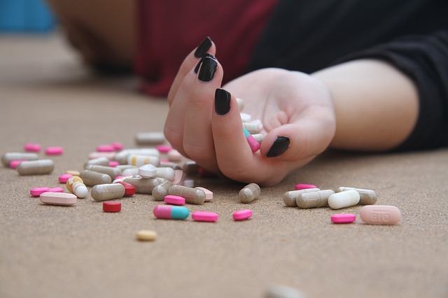 "Pills spilled on the floor next to an inert girl."