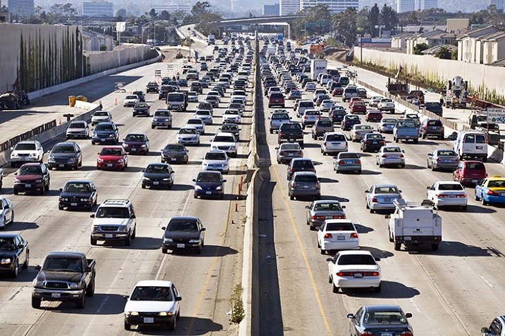 alt"Cars and trucks choke the San Diego Freeway in both directions during the afternoon rush hour in Los Angeles near an interchange"