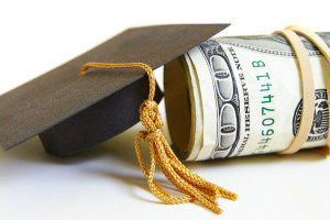 closeup of graduation cap and cash roll