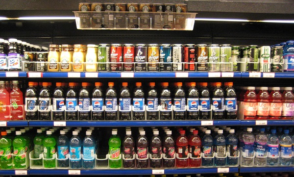 several shelfs with soda drinks