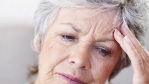 Old woman experiencing a migraine