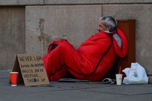 Homeless man in a red sleeping bag