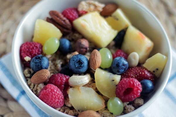 Bowl of oatmeal, fresh fruit and nuts
