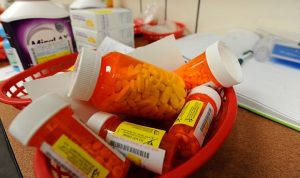 Prescription drugs in a red plastic basket