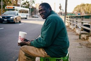 Black homeless man begging