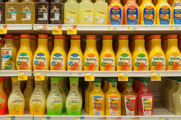 Orange juice bottles on Whole Foods shelves