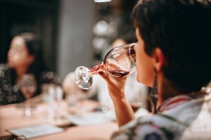 Woman drinking wine in restaurant